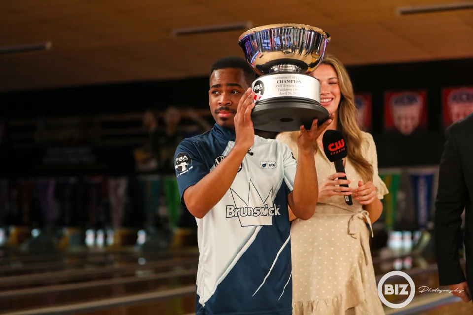 Tournament winner raising the PBA Tournament of Champions trophy