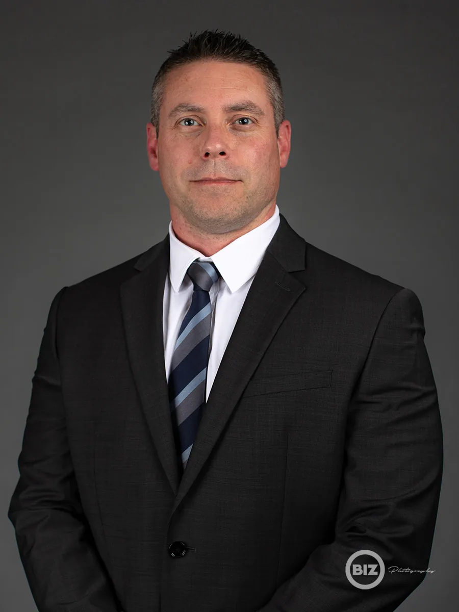Professional headshot of a man in a suit