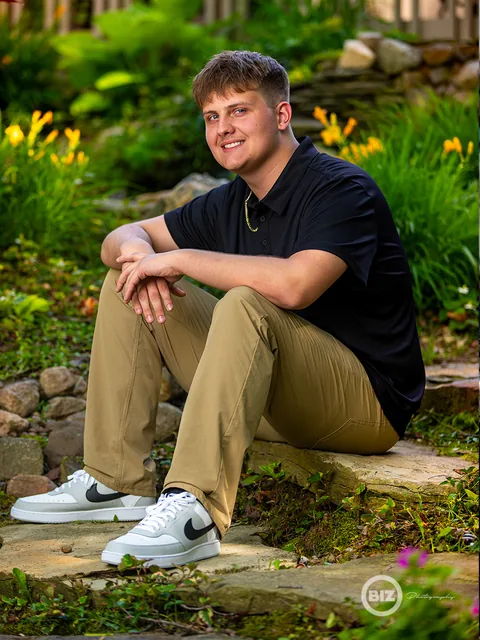 Brayden seated outdoors during his senior portrait session